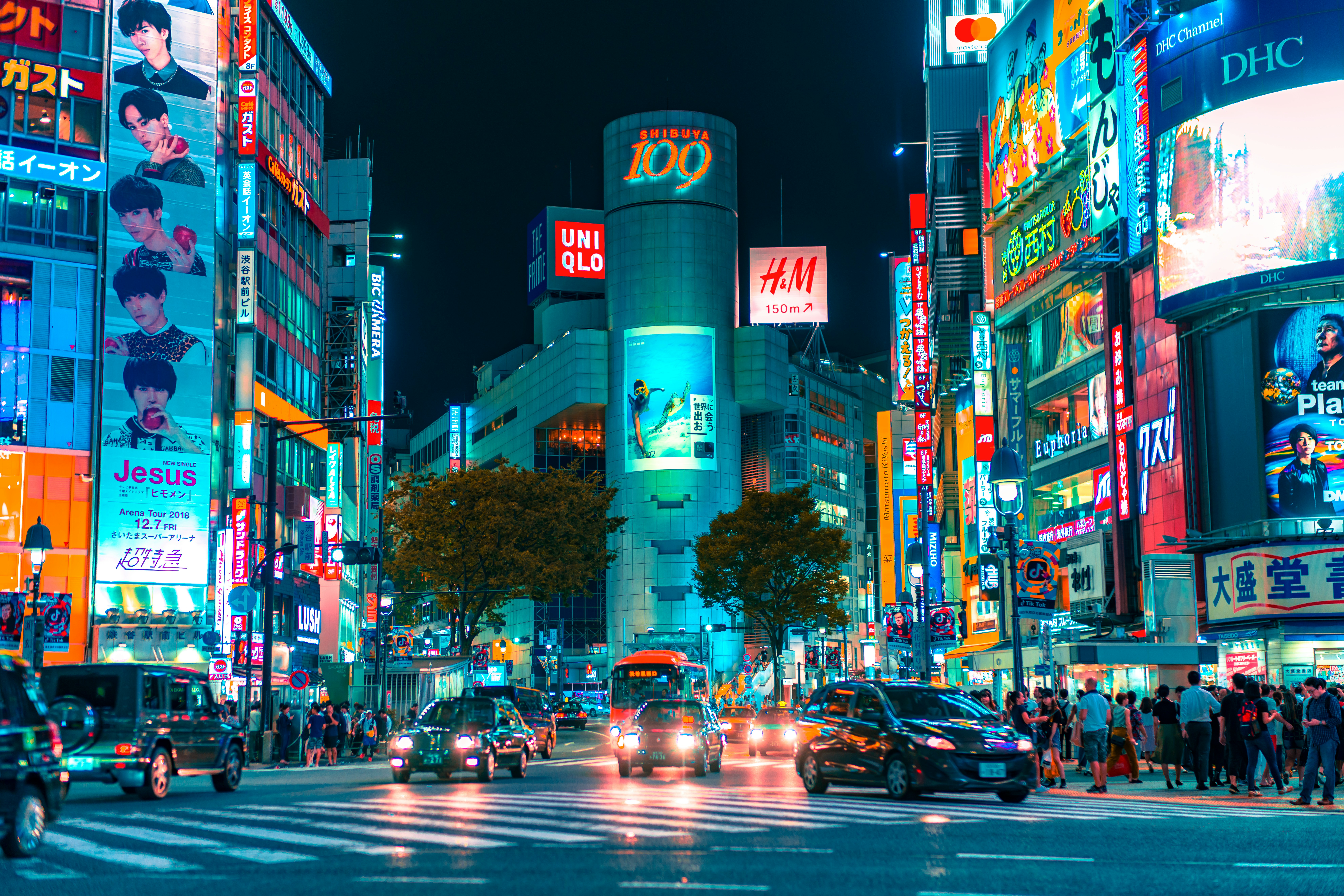 Busy street crossing in Tokyo at night