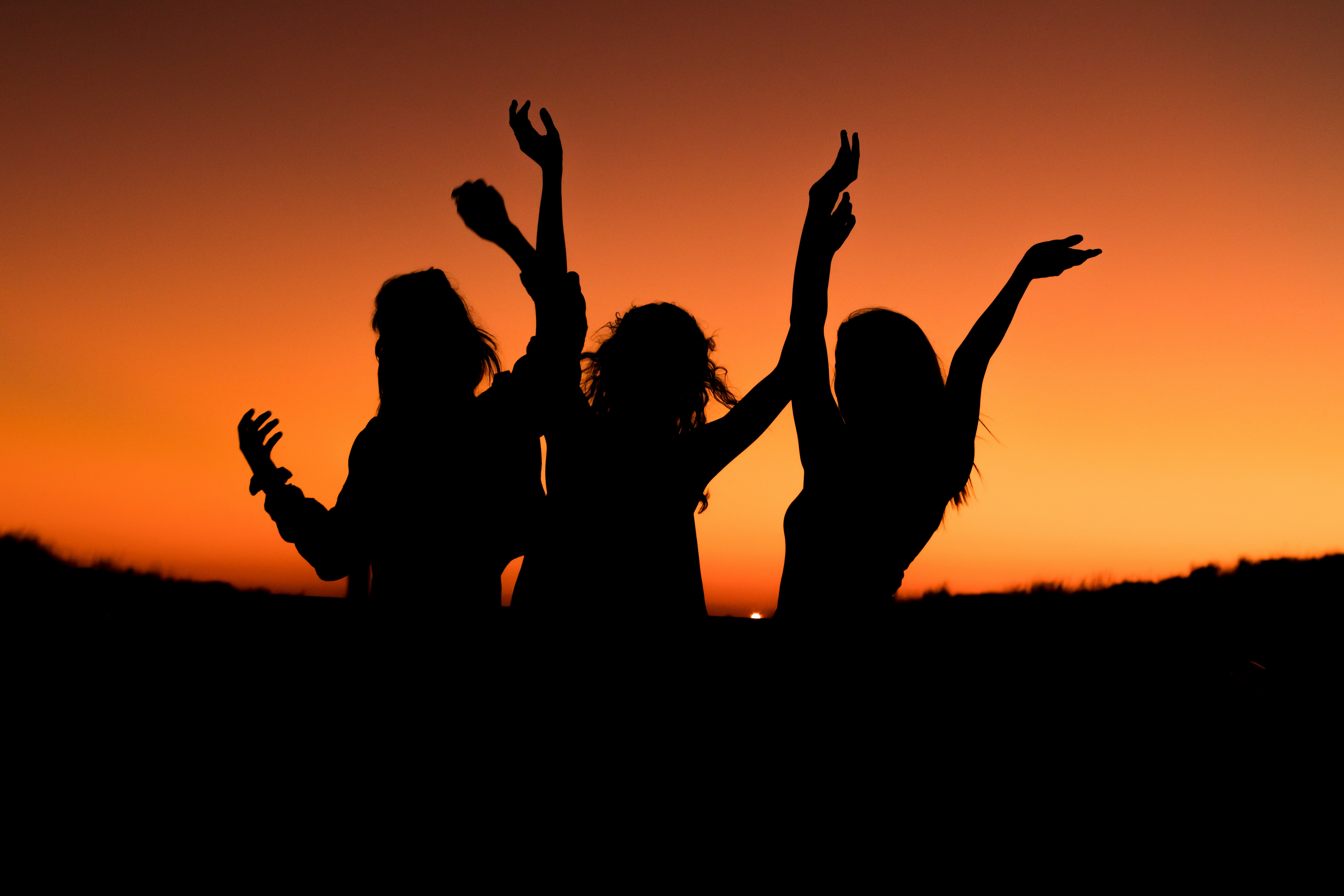 Women celebrating at sunset